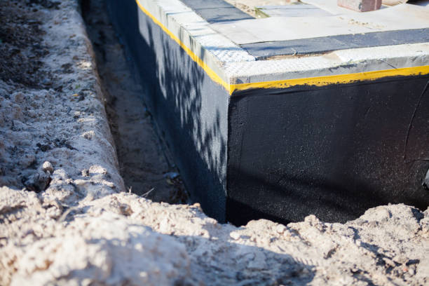 Professional Basement Waterproofing technician working in Arab, AL